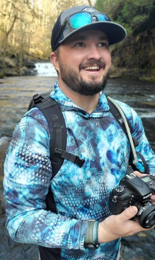 Brandon Miller shooting photos on a river